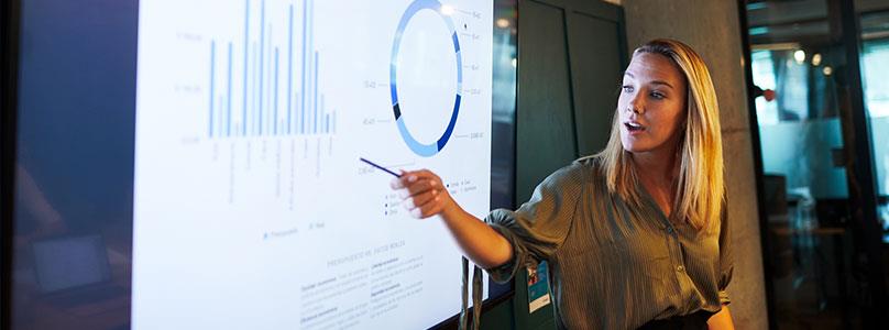 business person showing graphs on screen