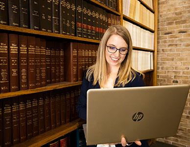 paralegal student researching in library