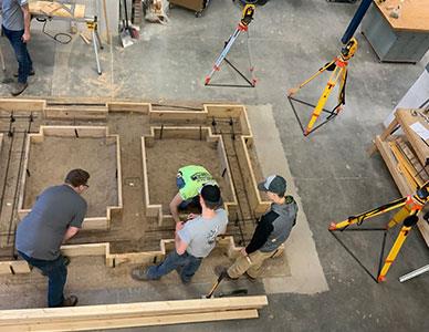 construction team laying a building foundation