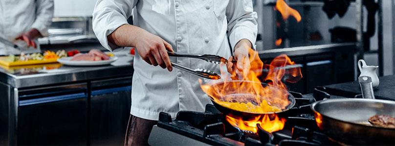 student cooking over a gas stove