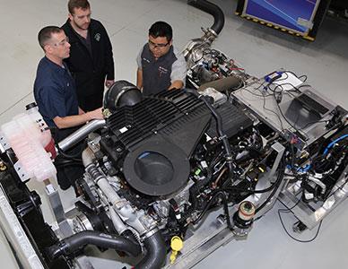 students and instructor in a diesel engine lab