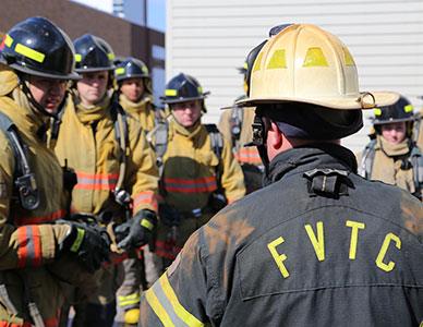 firefighter instructor and students in lab