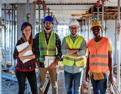 Four people on the job at a building construction site.