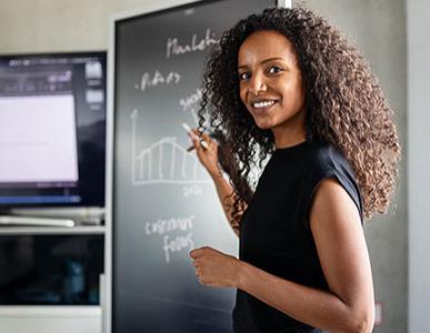 woman standing by chalkboard