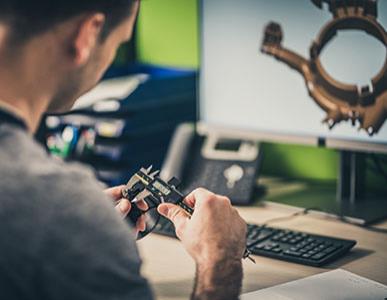 person working at computer on mechanical design